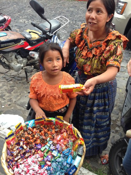 A little girl selling candy on the streets of Antigua, Guatemala