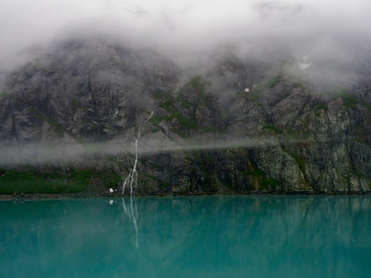 Waterfalls coming from the snow topped mountains in Glacier Bay, Alaska