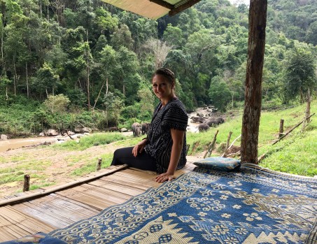 Watching the elephants play in the river at the Elephant Jungle Sanctuary outside of Chiang Mai, Thailand